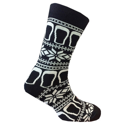 These socks, known as the Guinness Black & White Pint Socks from the Guinness Webstore UK, feature a blend of white geometric and snowflake patterns on a black base, perfectly capturing the festive spirit with a hint of Irish charm.