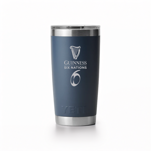 The Guinness Six Nations Yeti 20oz Tumbler in navy from Guinness Webstore UK features double-wall vacuum insulation, a stainless steel build, "YETI" branding at the base, and the tournament logo on its matte finish.