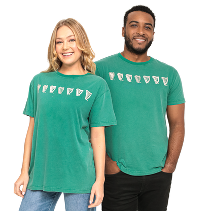 A man and a woman wearing green Guinness Evolution Harp Green T-Shirts.