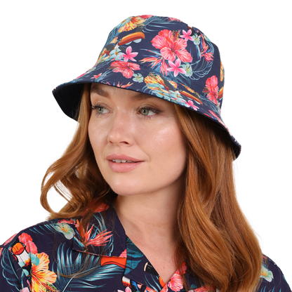 A person with red hair wearing a Guinness Hawaiian Reversible Bucket Hat from Guinness Webstore UK and a matching shirt looks to the side.