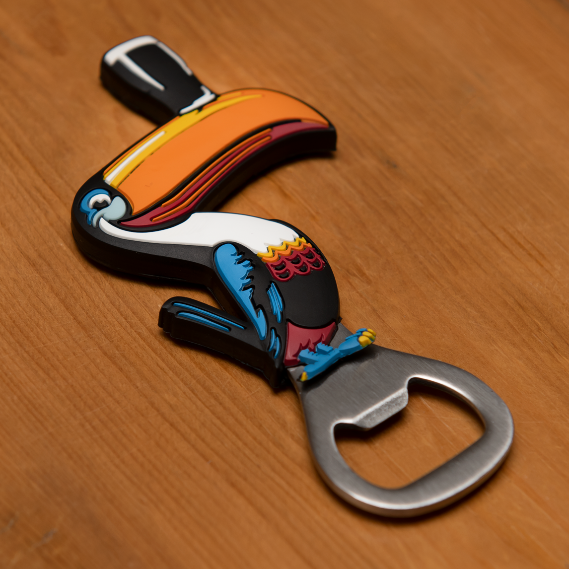 The Guinness Toucan Pvc Opener Magnet features a colorful toucan design and functions as both a bottle opener and an elegant magnet on any wooden surface.