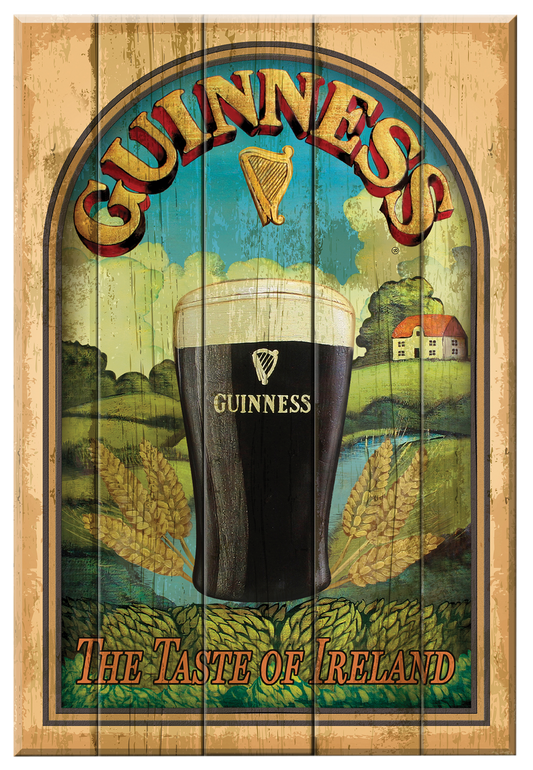 The Guinness Nostalgic Sign - Taste Of Ireland by Guinness UK features a vintage wall plaque design with a pint of beer, wheat, and a serene landscape. The piece reads "Guinness: The Taste of Ireland" alongside the iconic harp logo, and offers a charming weathered wood effect that encapsulates the classic essence of Ireland's cherished brew.