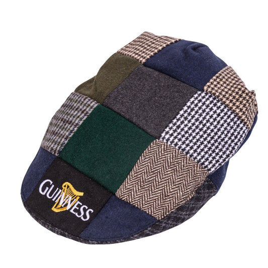 Multicolored patchwork flat cap with a traditional Irish design and a "Guinness Tweet Cap" logo embroidered on the front.