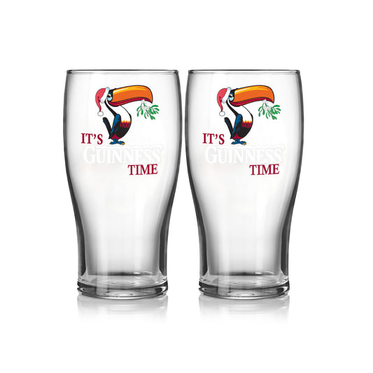 Celebrate the festive season with the limited-edition Guinness Christmas Toucan Pint Glass - 2 Pack by Guinness UK, featuring a charming toucan with mistletoe and a Santa hat. The glasses boldly proclaim "It's Guinness Time," making them perfect for holiday gatherings.