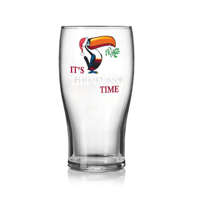 The Guinness Christmas Toucan Pint Glass features a festive toucan with a Santa hat and mistletoe, plus the words "It's Guinness Time," making it perfect for holiday celebrations.