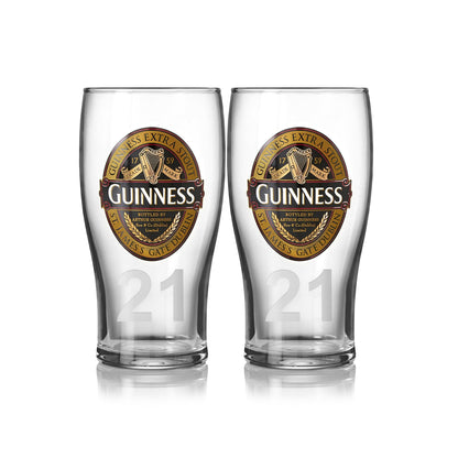 A 2-pack of pint glasses from Guinness UK, featuring the iconic logo and "21," embodies the timeless charm of the Guinness Classic Collection.