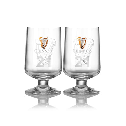 A pair of 420ml clear glasses embossed with the iconic Guinness Harp logo and symbols from Guinness UK, set against a white background.