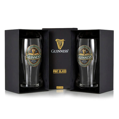 A sleek black box, labeled "Pint Glass" and adorned with the Guinness logo, holds two elegant boxed pint glasses from the esteemed Guinness Ireland Collection.