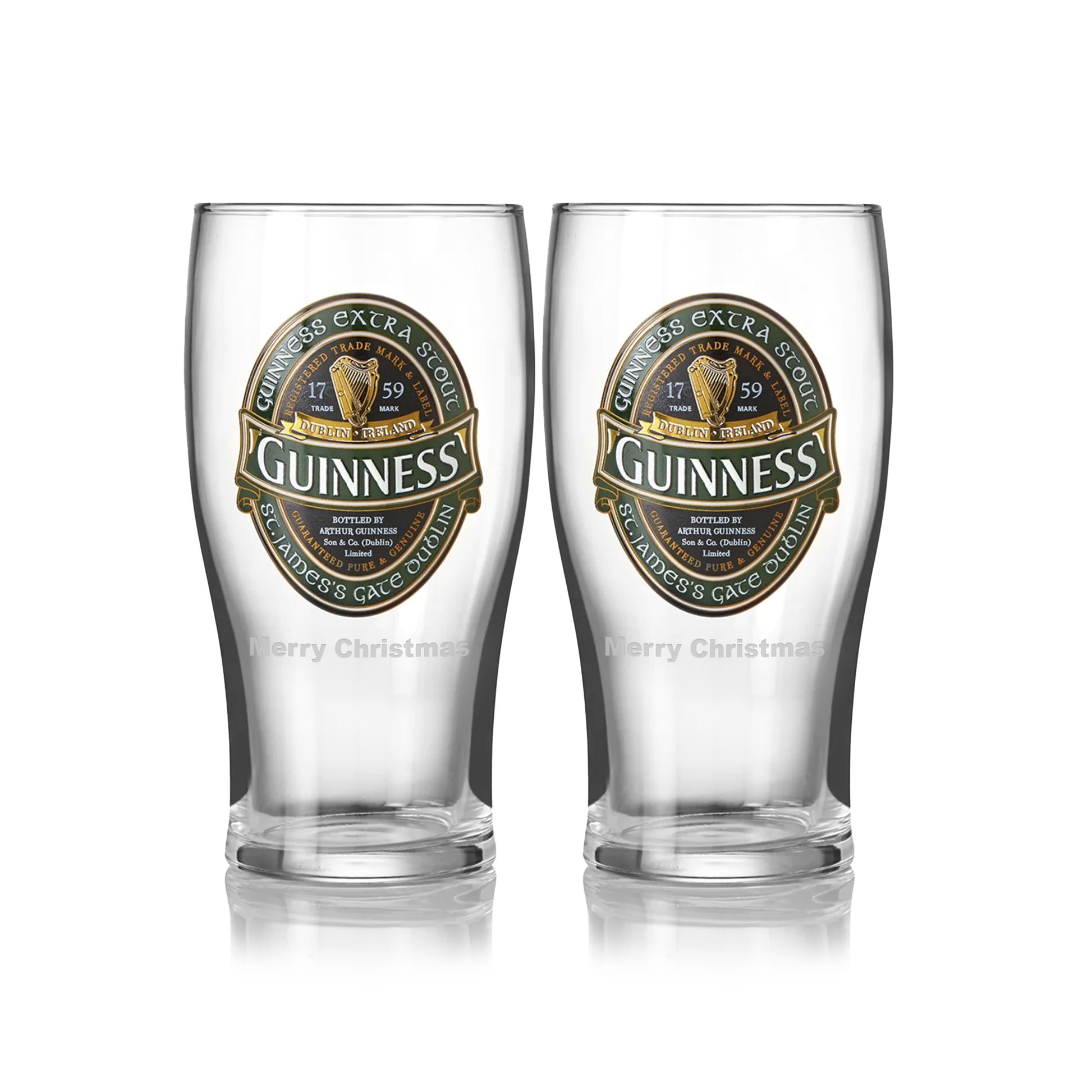 The Guinness Ireland Collection Pint Glass - 2 Pack includes two empty glasses featuring the Guinness logo and "Merry Christmas" at the bottom.