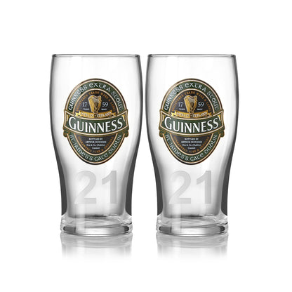 The Guinness Ireland Collection Pint Glass 2-Pack features two pint glasses with the iconic logo and branding, plus the number 21 near the base. Ideal for enjoying your favorite Extra Stout from this exclusive Guinness collection.