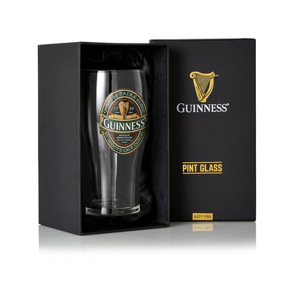 The Guinness Ireland Collection Pint Glass features the iconic Extra Stout label and harp emblem, packaged in a black box with gold lettering, capturing the essence of Guinness's rich heritage.