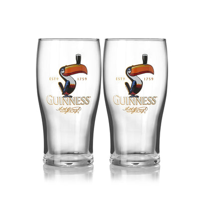 The Guinness Toucan Pint Glass - 2 Pack, from Guinness UK, features the iconic toucan and "Guinness" logo with gold text and decorative elements, making it the perfect official merchandise.