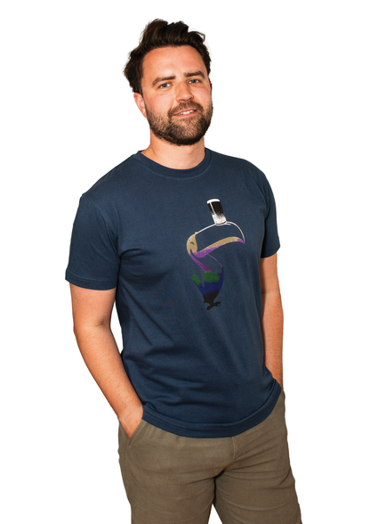 A man wearing a Guinness Liquid Toucan Tee - Blue, promoting sustainability through the Better Cotton Initiative.
