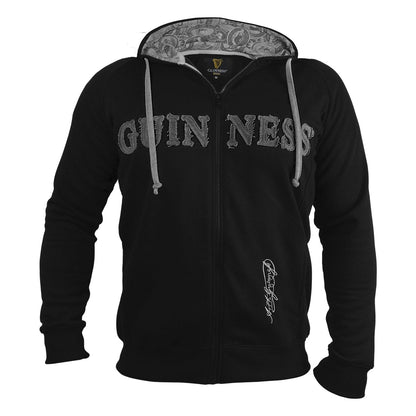 The Guinness Vintage Black & Grey Label Lined Hoodie from the Guinness Webstore UK is a stylish black zip-up featuring "Guinness" embroidered prominently across the chest and a signature design near the pocket. It has a patterned interior lining in the hood and white drawstrings, adding to its vintage label appeal.