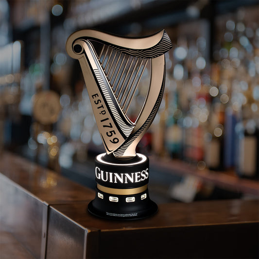 A Guinness UK Universal USB Bar Charger, a collectable piece of Guinness memorabilia, sitting on top of a bar.
