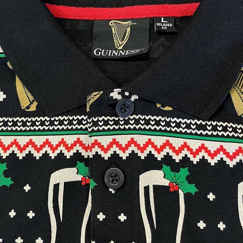 Close-up of a Guinness Festive Pints Polo Shirt featuring black fabric adorned with festive patterns, perfect for making a unique holiday fashion statement at joyful gatherings.