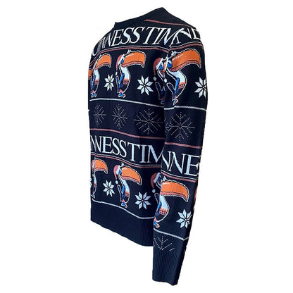 The Guinness Christmas Toucan Jumper from Guinness is a cozy black knitwear item that features a repeating pattern of toucans, snowflakes, and the phrase "GUINNESS TIME.