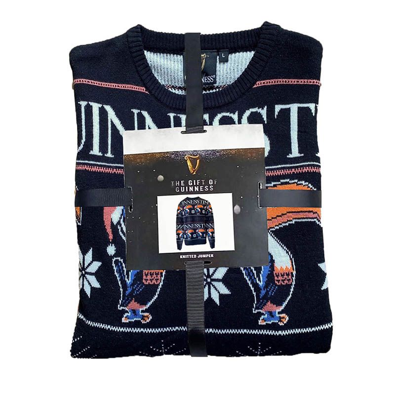 This cozy black jumper, featuring the iconic Guinness branding and a festive design with a charming Toucan motif, comes with a gift tag that says "The Gift of Guinness.