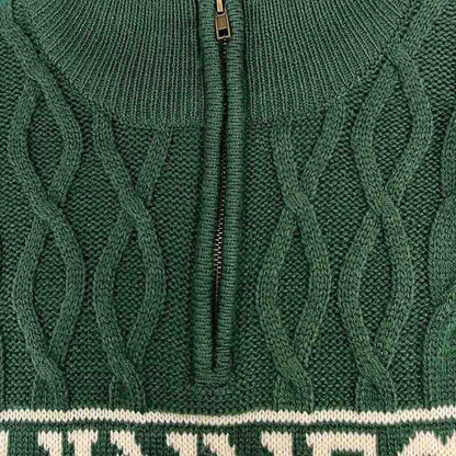 Close-up of the Guinness Green Cable Knit Quarter Zip Jumper, featuring a partial zipper and white text along the bottom edge.