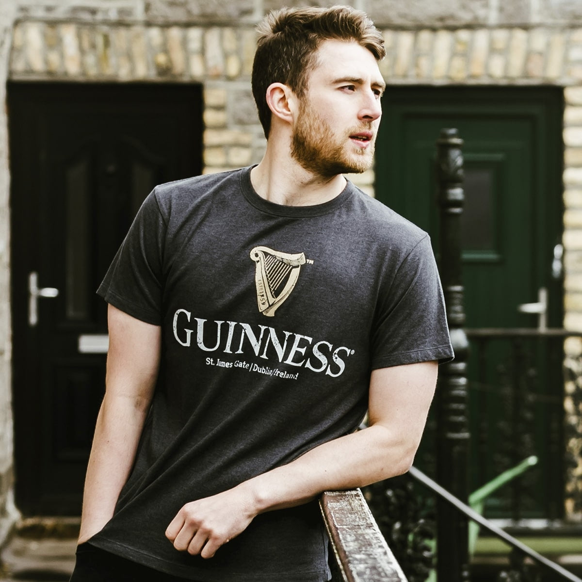 A Guinness Navy man leaning on a railing.