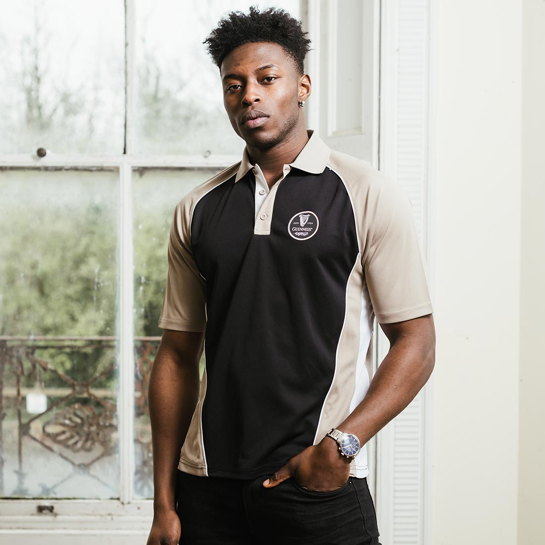 A man wearing a Guinness Performance Panelled Golf Shirt by Guinness UK.