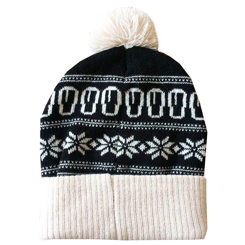 Introducing the Guinness Christmas Black & White Pint Beanie by Guinness: a cozy winter accessory featuring a stylish black and white geometric design, complete with a festive pom-pom on top and a beige folded brim, perfect for enhancing your seasonal wardrobe.