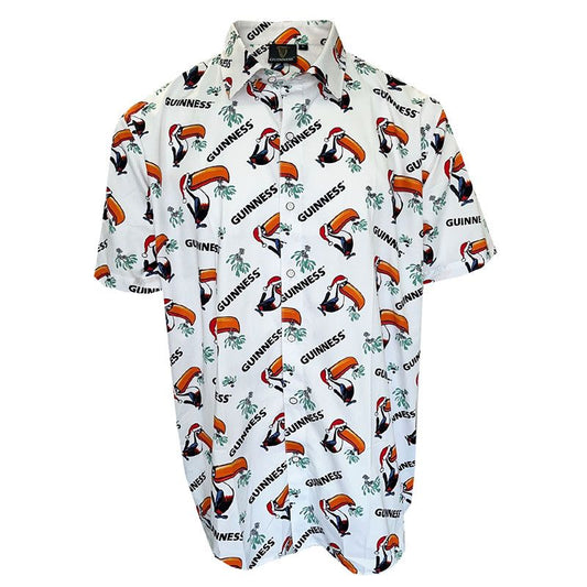 The Guinness Christmas Toucan Shirt, available through the Guinness Webstore UK, is a festive short-sleeve button-up featuring toucans, "Guinness" text, and small green harp motifs on a white background—ideal for any Guinness fan celebrating Christmas in style.