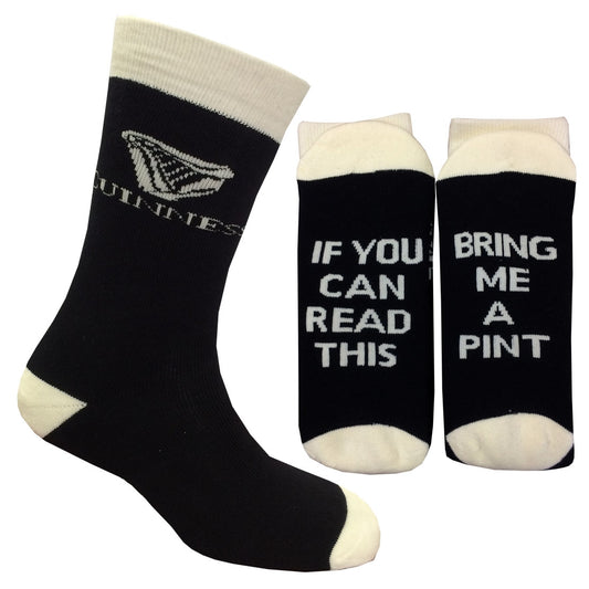 A novelty pair of Guinness UK 'Bring me a Pint' socks featuring black and white colors with the words "if you can read me" printed on them.