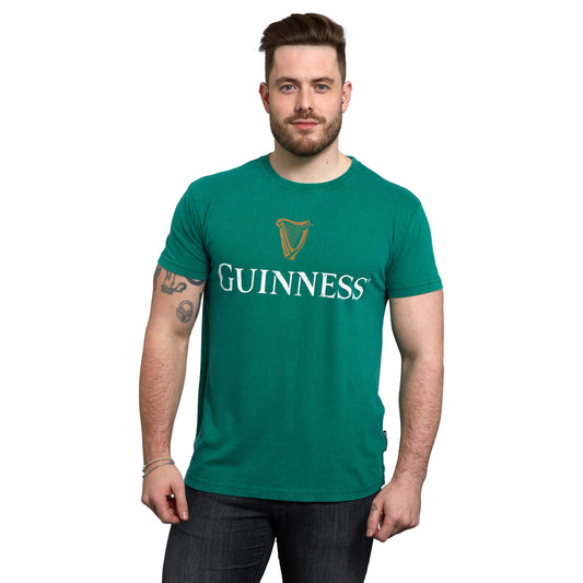 An Irish man proudly donning a premium green Guinness UK T-shirt featuring the iconic Guinness Harp.