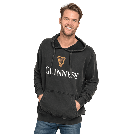 A man donning a stylish Guinness UK Premium Harp Hoodie.