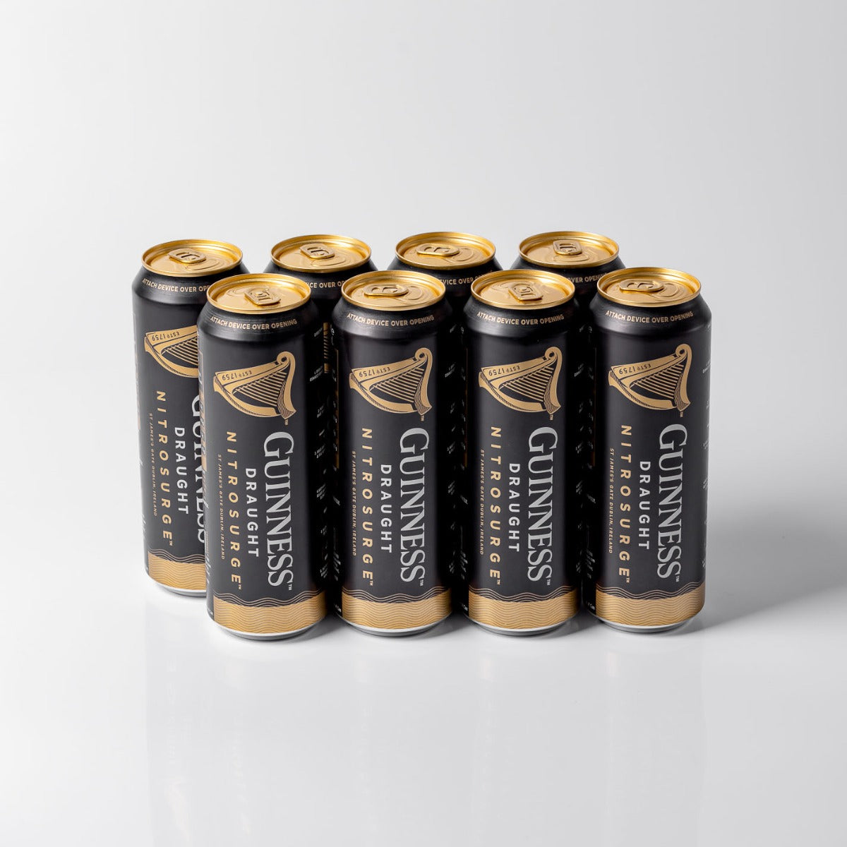 A group of nine cans from the Guinness Nitrosurge Gift Bundle by Guinness UK are arranged on a white surface, with their nitrogen bubbles promising a perfect, creamy pour every time.