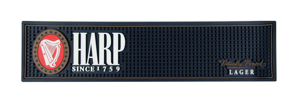 The Harp Lager PVC Bar Mat by Guinness UK features the iconic "Harp" logo, with the text "Since 1759" on the left and "Naturally Brewed Lager" on the right, making it a perfect addition to your home bar setup.