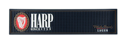 The Harp Lager PVC Bar Mat by Guinness UK features the iconic "Harp" logo, with the text "Since 1759" on the left and "Naturally Brewed Lager" on the right, making it a perfect addition to your home bar setup.