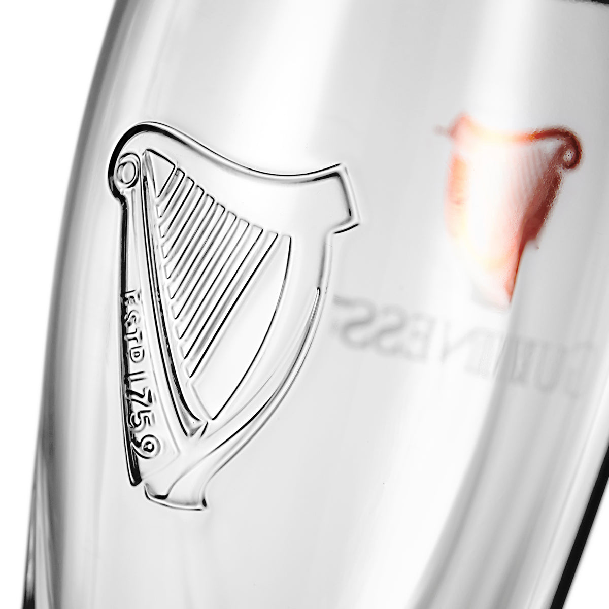 A close up of a Guinness Pint Glass - 2 Pack with the Guinness UK harp on it.