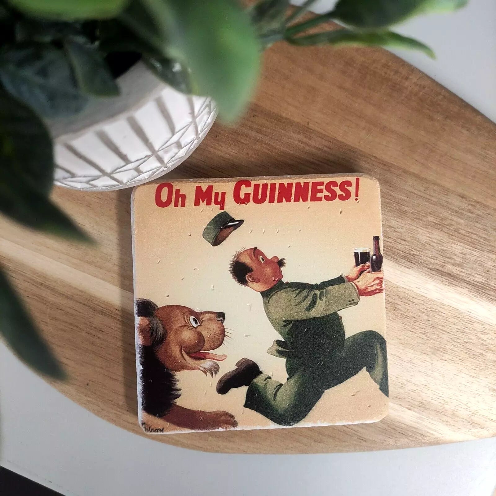 A vintage-style illustration featuring a lion and zookeeper from Gilroy adorns the Guinness Stone Effect Coaster, ideal for any fan of Guinness.