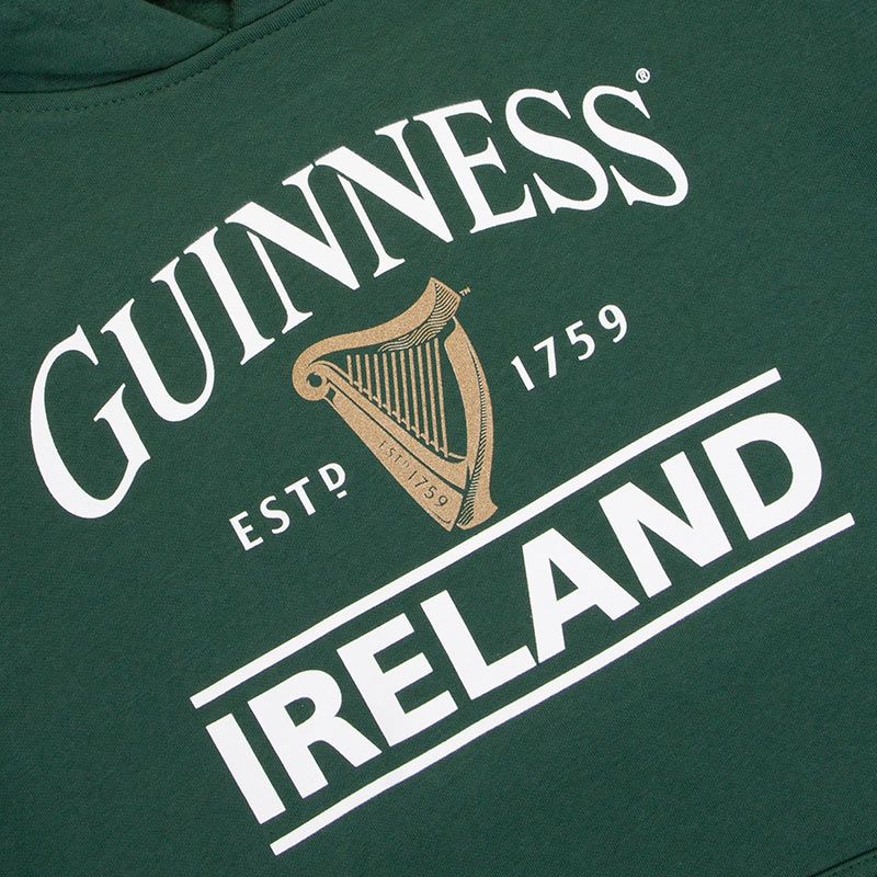 Close-up of a GUINNESS Bottle Green Unisex Hoodie featuring the white logo of Guinness beer, including a harp and the text "Guinness est. 1759 Ireland.