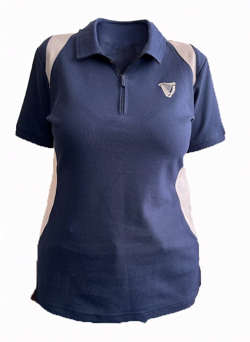 The Ladies Performance Polo - Blue from Guinness Webstore UK features short sleeves, white side panels, a zippered collar, and an embroidered left chest logo, made from premium 210gsm double pique fabric for all-day comfort.